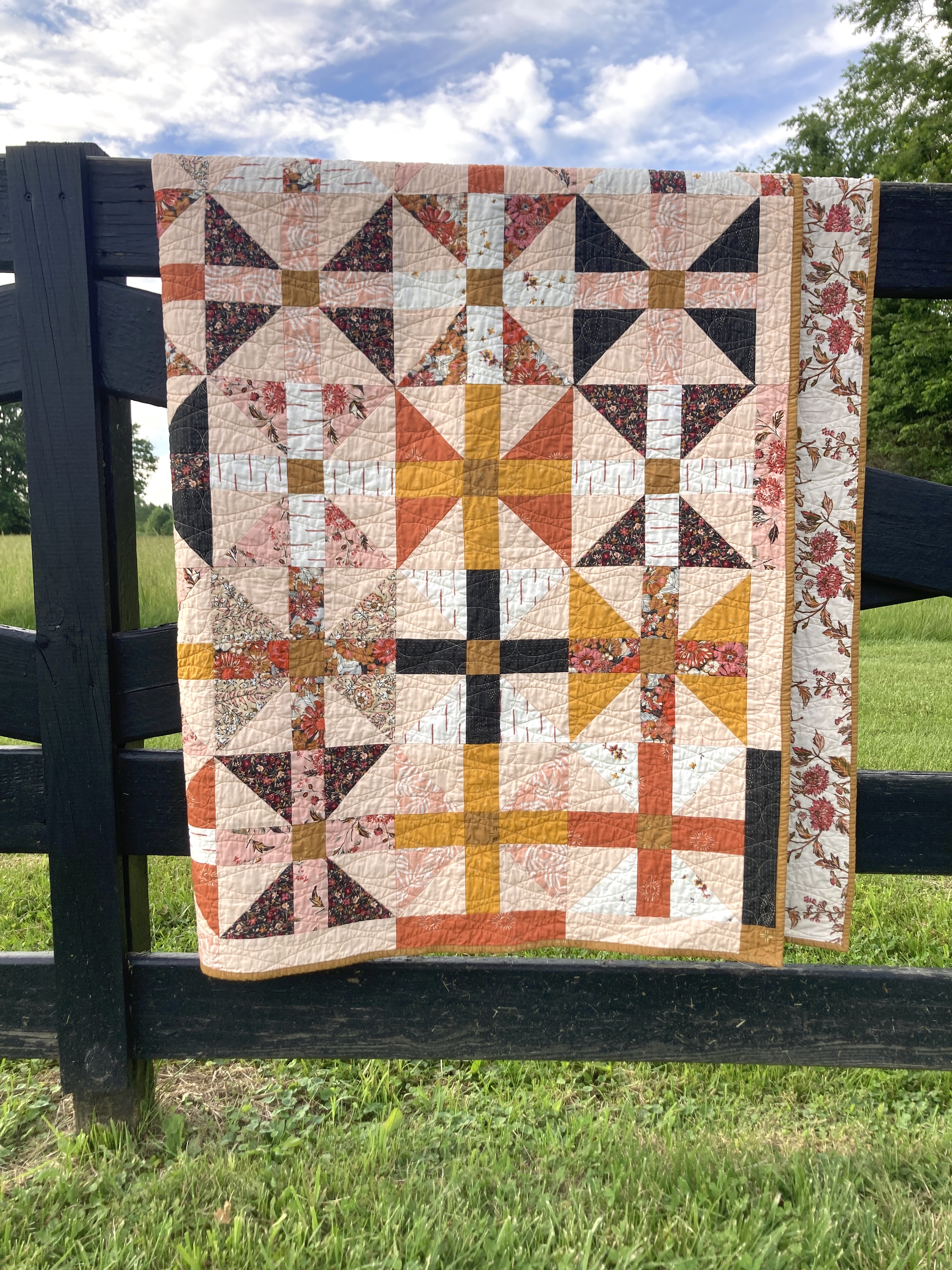 A quilt of hourglass blocks in autumn colors